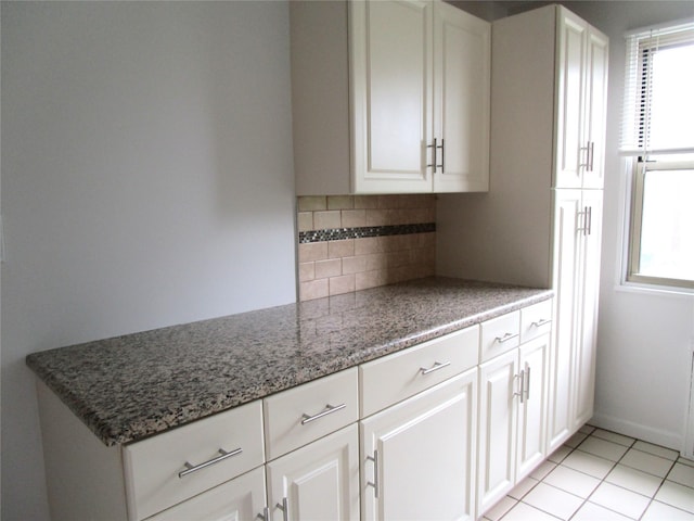 324 Post Ave Apt 8-J, Westbury, NY 11590 - kitchen featuring plenty of natural light, tasteful backsplash, and white cabinetry