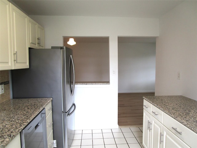 324 Post Ave Apt 8-J, Westbury, NY 11590 - kitchen with dishwasher, light stone countertops, white cabinets, and decorative backsplash