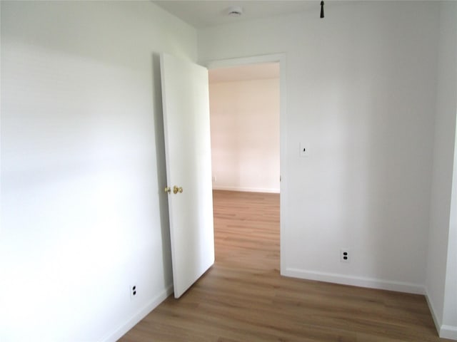 324 Post Ave Apt 8-J, Westbury, NY 11590 - unfurnished room with light wood finished floors and a smoke detector