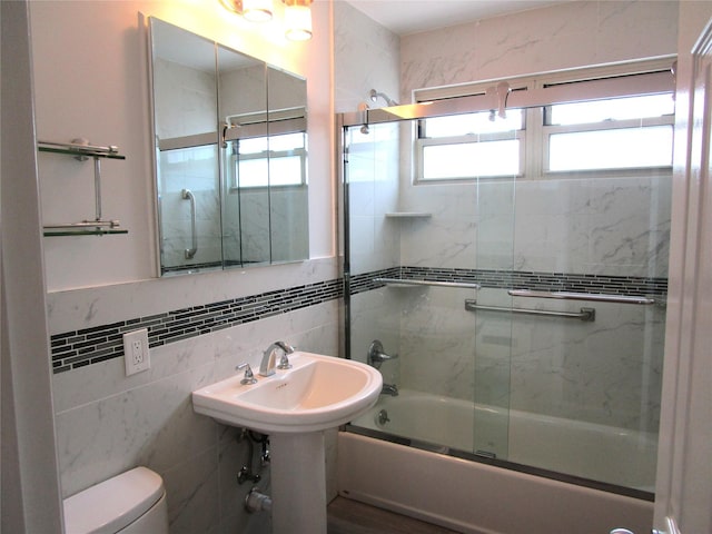 324 Post Ave Apt 8-J, Westbury, NY 11590 - bathroom featuring shower / bath combination with glass door and tile walls