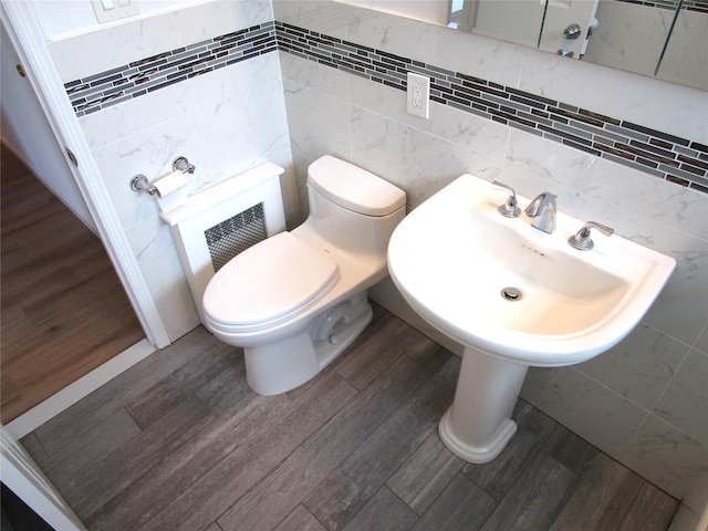 324 Post Ave Apt 8-J, Westbury, NY 11590 - half bath featuring tile walls and wood finished floors