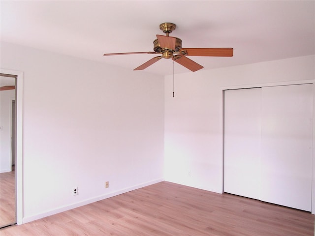 324 Post Ave Apt 8-J, Westbury, NY 11590 - unfurnished bedroom featuring light wood-style flooring, a closet, and ceiling fan