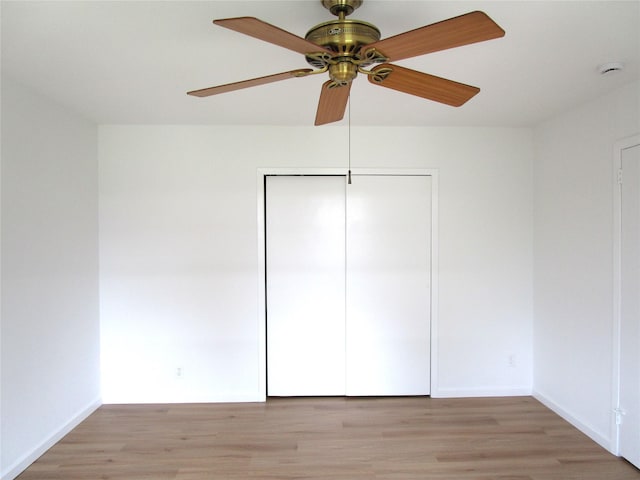 324 Post Ave Apt 8-J, Westbury, NY 11590 - unfurnished bedroom featuring light wood-style flooring, a closet, and ceiling fan