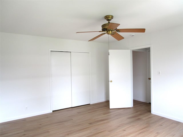 324 Post Ave Apt 8-J, Westbury, NY 11590 - unfurnished bedroom featuring light wood-type flooring, a closet, and a ceiling fan