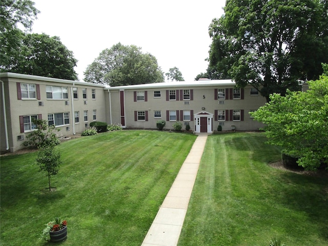 324 Post Ave Apt 8-J, Westbury, NY 11590 - view of front facade with a front lawn