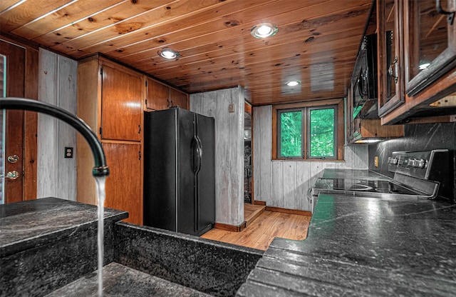 444 Buttermilk Falls Rd, Warwick, NY 10990 - kitchen featuring black appliances, brown cabinetry, dark countertops, light wood-style flooring, and recessed lighting