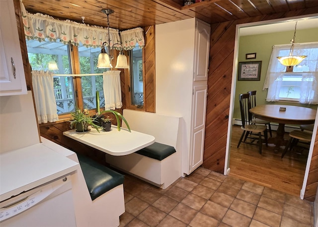 103 Arlington Rd, Lake Ronkonkoma, NY 11779 - dining area featuring wood ceiling, healthy amount of natural light, and wood walls