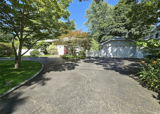 103 Arlington Rd, Lake Ronkonkoma, NY 11779 - view of property hidden behind natural elements with a garage and driveway