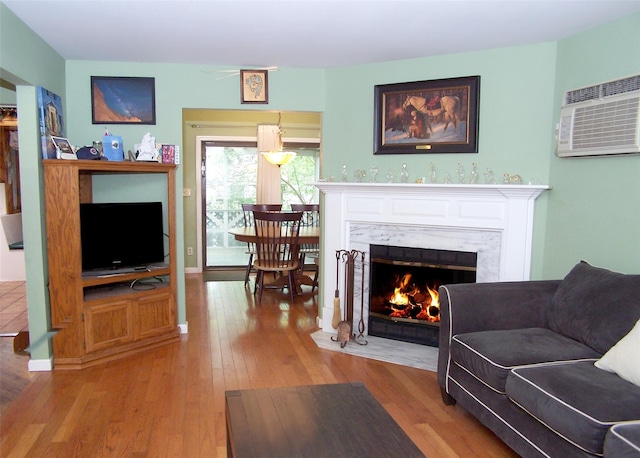 103 Arlington Rd, Lake Ronkonkoma, NY 11779 - living room featuring wood finished floors, a fireplace, and a wall unit AC