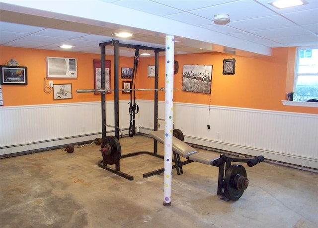 103 Arlington Rd, Lake Ronkonkoma, NY 11779 - exercise area with a wall unit AC, a wainscoted wall, a drop ceiling, and a baseboard heating unit