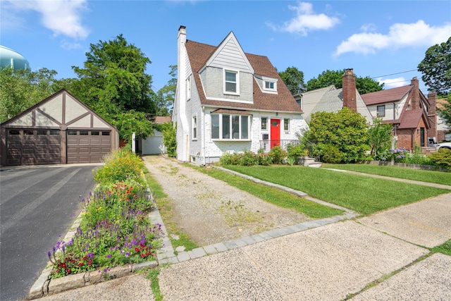 1644 Kenneth Ave, Baldwin, NY 11510 - view of front of house featuring a garage, a chimney, an outdoor structure, a front lawn, and roof with shingles