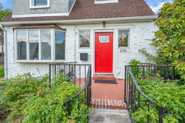 1644 Kenneth Ave, Baldwin, NY 11510 - doorway to property featuring a shingled roof and brick siding