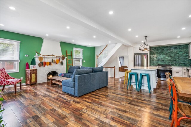 1644 Kenneth Ave, Baldwin, NY 11510 - living room with dark wood-style flooring, recessed lighting, a fireplace, and stairway