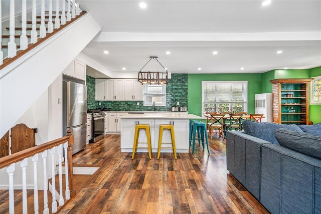 1644 Kenneth Ave, Baldwin, NY 11510 - kitchen with appliances with stainless steel finishes, open floor plan, dark wood-style flooring, white cabinets, and recessed lighting