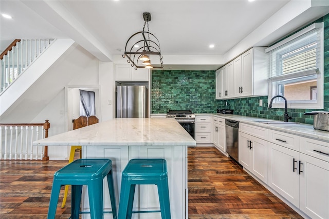 1644 Kenneth Ave, Baldwin, NY 11510 - kitchen featuring stainless steel appliances, a kitchen island, light stone countertops, a breakfast bar, and tasteful backsplash