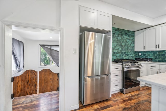 1644 Kenneth Ave, Baldwin, NY 11510 - kitchen with appliances with stainless steel finishes, white cabinets, decorative backsplash, and dark wood-style flooring