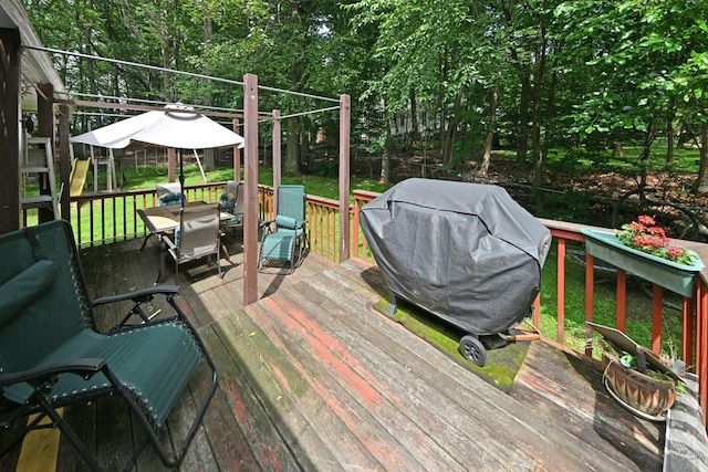 17 E Stemmer Ln, Suffern, NY 10901 - wooden deck with outdoor dining area, a grill, and a lawn