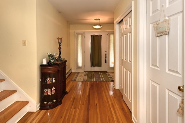17 E Stemmer Ln, Suffern, NY 10901 - hallway featuring wood finished floors, a baseboard heating unit, and stairway
