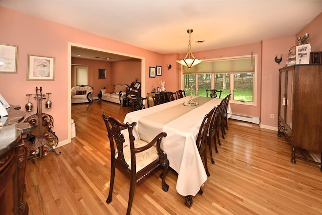 17 E Stemmer Ln, Suffern, NY 10901 - dining room featuring a baseboard heating unit and light wood-style flooring