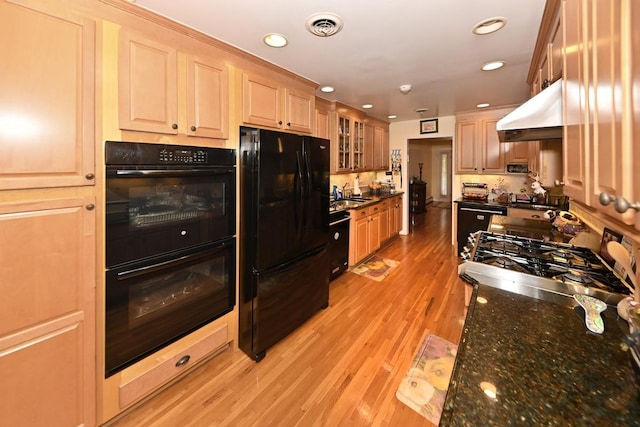 17 E Stemmer Ln, Suffern, NY 10901 - kitchen with black appliances, under cabinet range hood, light wood-type flooring, glass insert cabinets, and recessed lighting
