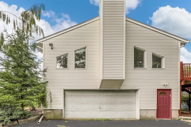28 Lime Kiln Rd, Suffern, NY 10901 - view of front of home featuring an attached garage and a chimney