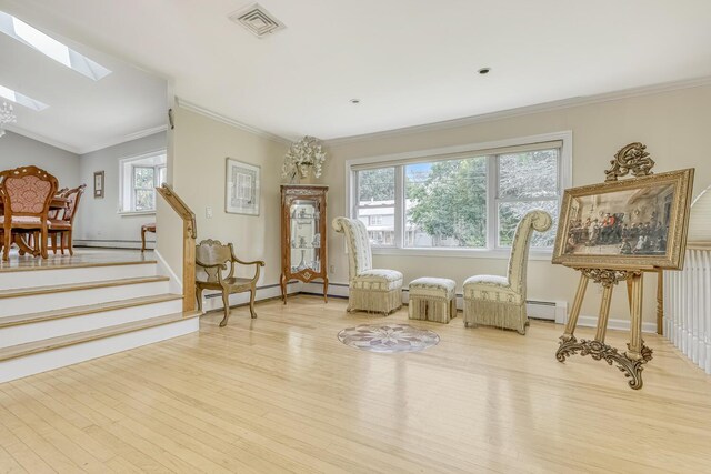 28 Lime Kiln Rd, Suffern, NY 10901 - living area featuring a baseboard heating unit, wood finished floors, a skylight, ornamental molding, and baseboard heating