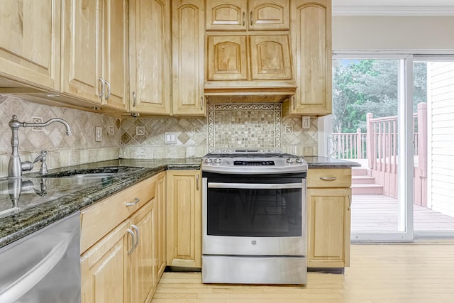 28 Lime Kiln Rd, Suffern, NY 10901 - kitchen with appliances with stainless steel finishes, light brown cabinetry, light wood-type flooring, dark stone counters, and ornamental molding