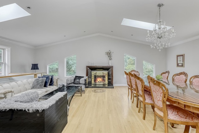 28 Lime Kiln Rd, Suffern, NY 10901 - living room featuring a skylight, plenty of natural light, a chandelier, crown molding, and lofted ceiling