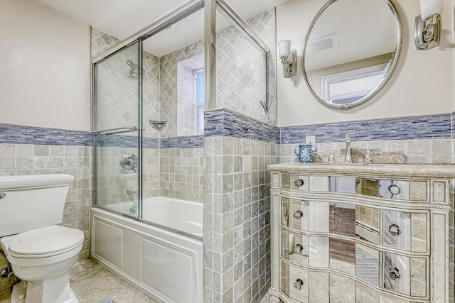 28 Lime Kiln Rd, Suffern, NY 10901 - full bath featuring tile walls, combined bath / shower with glass door, vanity, wainscoting, and marble finish flooring