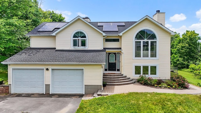 125 Whipple Rd, Middletown, NY 10940 - bi-level home with a chimney, asphalt driveway, and solar panels