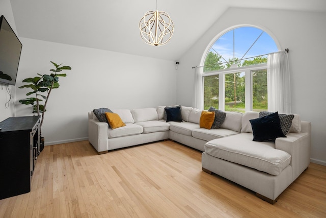 125 Whipple Rd, Middletown, NY 10940 - living room featuring a chandelier, vaulted ceiling, and light wood-style flooring