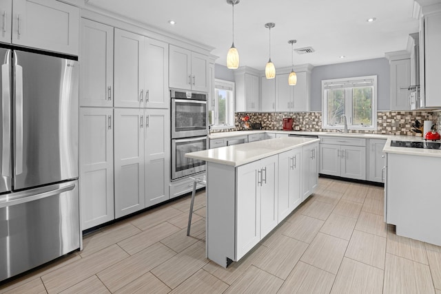 125 Whipple Rd, Middletown, NY 10940 - kitchen featuring stainless steel appliances, a center island, decorative backsplash, light countertops, and recessed lighting