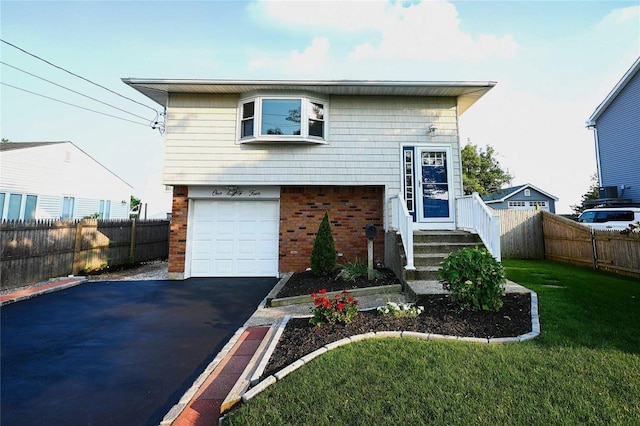 184 Sumpwams Ave, Babylon, NY 11702 - view of front facade with brick siding, asphalt driveway, and an attached garage