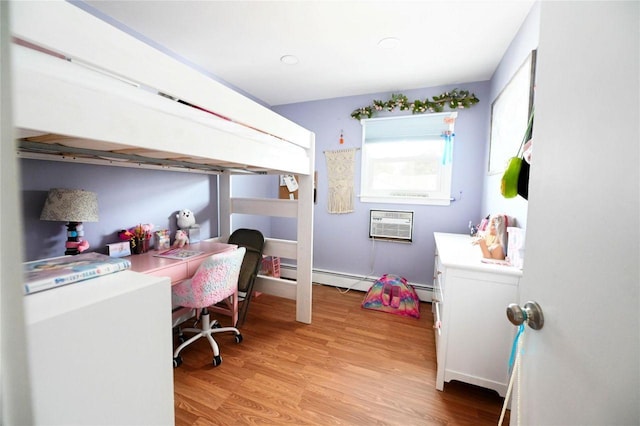 184 Sumpwams Ave, Babylon, NY 11702 - bedroom with light wood-style floors, a baseboard heating unit, a wall mounted air conditioner, and a desk
