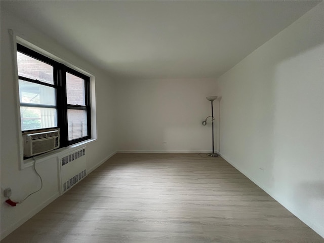 150-15 72nd Rd Unit 1A, Kew Garden Hills, NY 11367 - unfurnished room with radiator, wood finished floors, and cooling unit