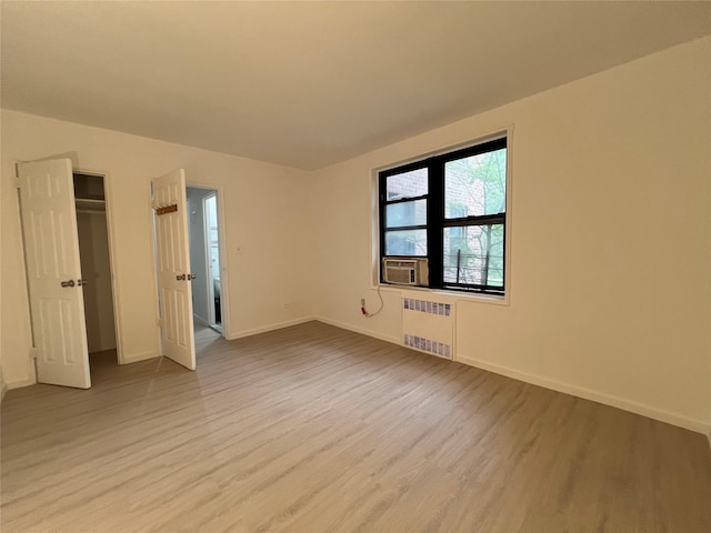 150-15 72nd Rd Unit 1A, Kew Garden Hills, NY 11367 - empty room featuring radiator heating unit and light wood-style floors
