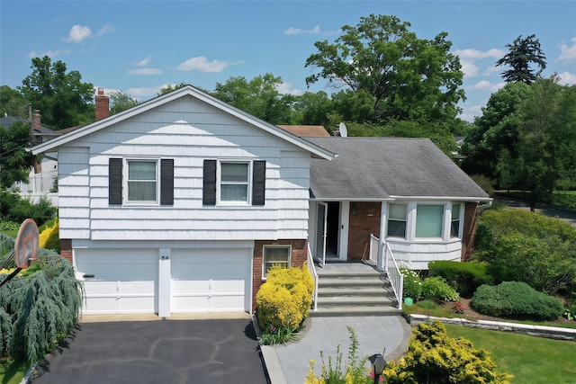64 Meadowfarm Rd, Manhasset Hills, NY 11040 - split level home with brick siding, an attached garage, asphalt driveway, and a chimney