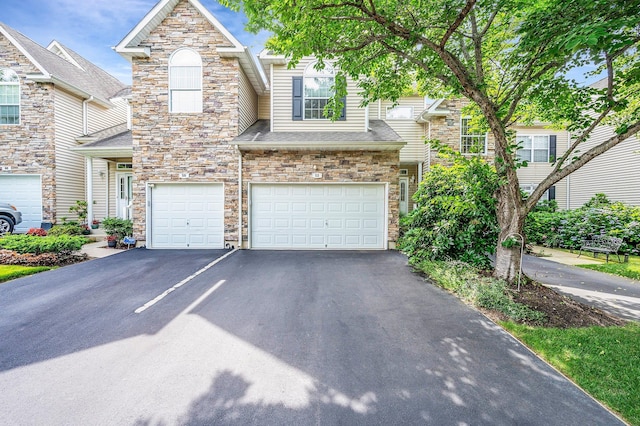 52 Mantack Path, Kings Park, NY 11754 - view of front of house featuring asphalt driveway, stone siding, and an attached garage