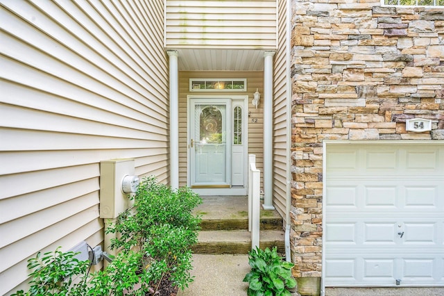 52 Mantack Path, Kings Park, NY 11754 - property entrance featuring stone siding and a garage