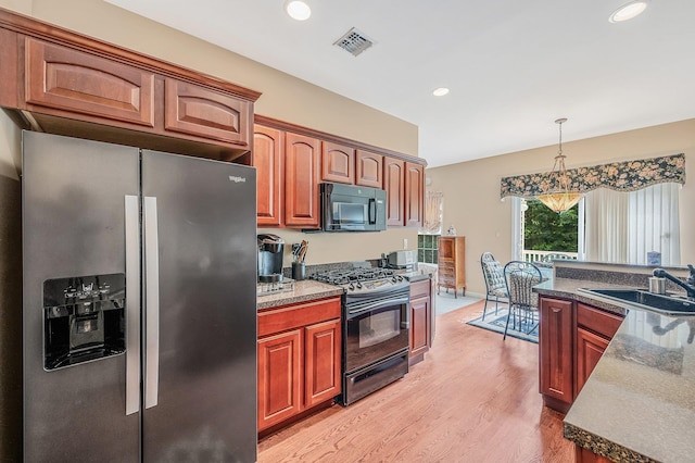 52 Mantack Path, Kings Park, NY 11754 - kitchen with stainless steel fridge, range with gas cooktop, black microwave, light wood-style floors, and pendant lighting