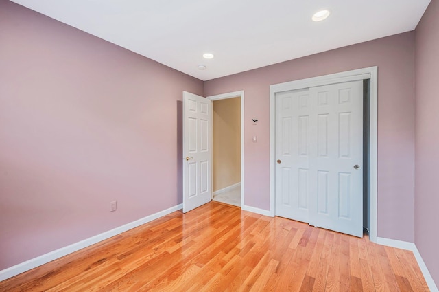 52 Mantack Path, Kings Park, NY 11754 - unfurnished bedroom featuring light wood-type flooring, recessed lighting, and a closet