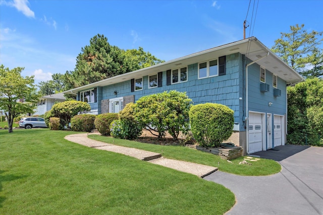 9 Bittersweet Ln, Glen Cove, NY 11542 - view of front of home featuring a garage, a front yard, and driveway
