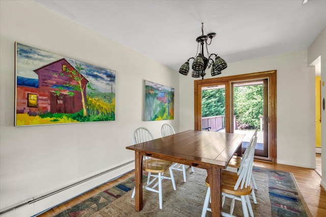 9 Bittersweet Ln, Glen Cove, NY 11542 - dining room with baseboard heating, a chandelier, and wood finished floors