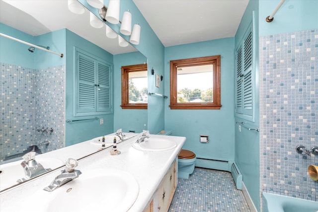 9 Bittersweet Ln, Glen Cove, NY 11542 - bathroom featuring a baseboard radiator, double vanity, tile patterned floors, and bathtub / shower combination