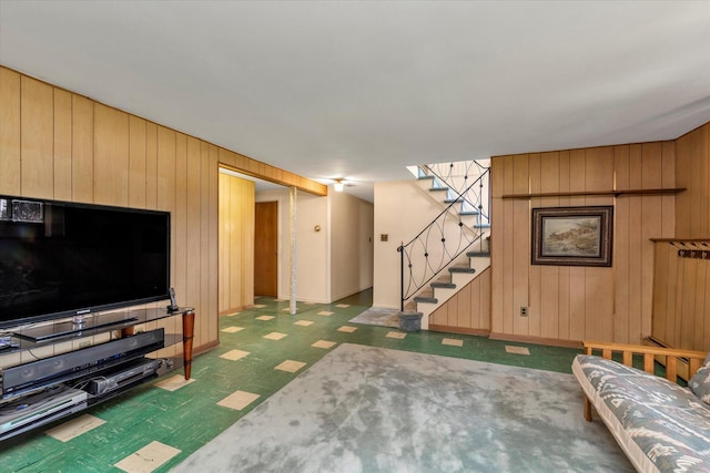 9 Bittersweet Ln, Glen Cove, NY 11542 - living area with wooden walls, dark floors, and stairs