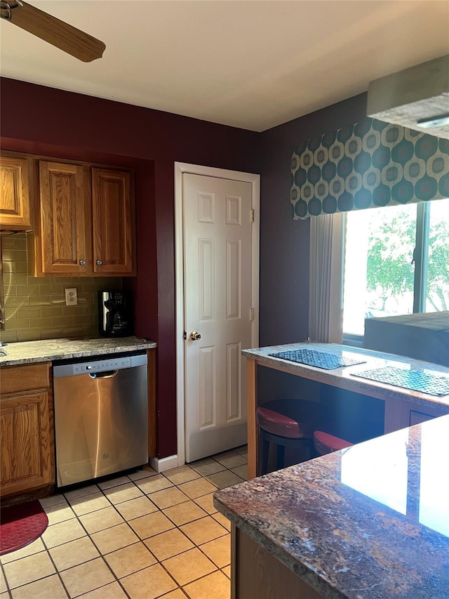 13 Butternut Ct, Highland Mills, NY 10930 - kitchen featuring stainless steel dishwasher, light tile patterned floors, brown cabinets, tasteful backsplash, and ceiling fan
