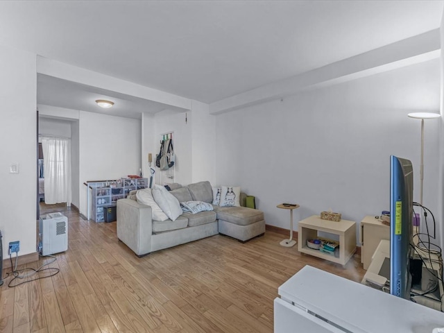 99-05 63rd Dr Unit 7R, Rego Park, NY 11374 - living area featuring light wood-style floors and baseboards