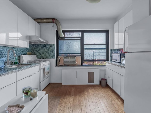 99-05 63rd Dr Unit 7R, Rego Park, NY 11374 - kitchen with white appliances, under cabinet range hood, white cabinetry, and healthy amount of natural light