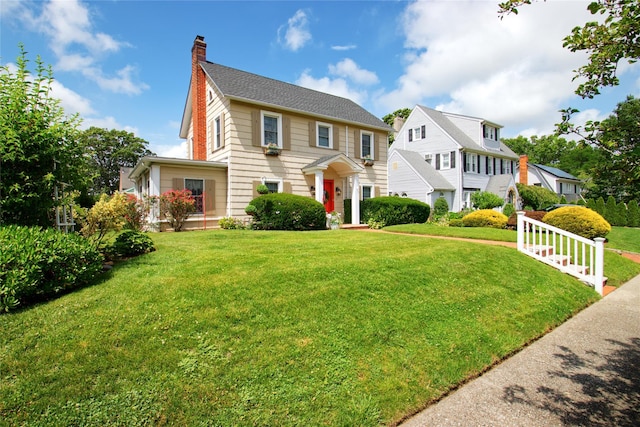 71 Hillcrest Ave, Manhasset, NY 11030 - colonial inspired home with a chimney and a front yard