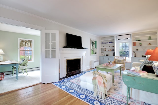 71 Hillcrest Ave, Manhasset, NY 11030 - living room with a baseboard heating unit, a wall mounted air conditioner, a fireplace with flush hearth, wood finished floors, and an office area